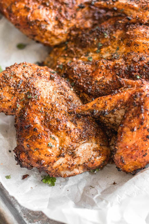 This recipe is for the best smoked butterfly chicken. It'll be your go-to method for smoking a whole chicken on a pellet grill that's Whole30, gluten-free, low carb and paleo. The dry rub is made with simple, sugar-free ingredients and by using the spatchcock method, the chicken skin gets crispy while keeping the meat tender, juicy and full of flavor. This is a great family friendly recipe that works well for meal prep, too. #whole30chicken #smokerrecipes #wholechicken #pelletgrill #butterflychicken