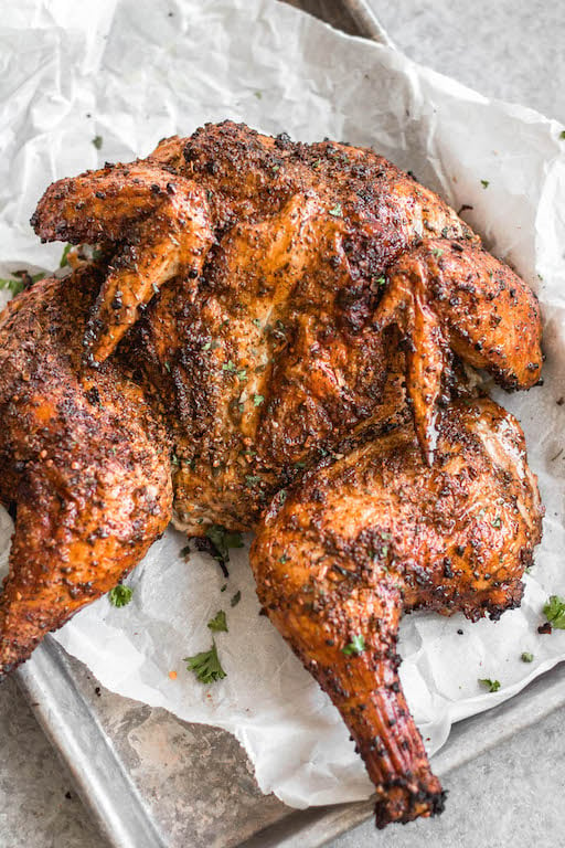 This recipe is for the best smoked butterfly chicken. It'll be your go-to method for smoking a whole chicken on a pellet grill that's Whole30, gluten-free, low carb and paleo. The dry rub is made with simple, sugar-free ingredients and by using the spatchcock method, the chicken skin gets crispy while keeping the meat tender, juicy and full of flavor. This is a great family friendly recipe that works well for meal prep, too. #whole30chicken #smokerrecipes #wholechicken #pelletgrill #butterflychicken