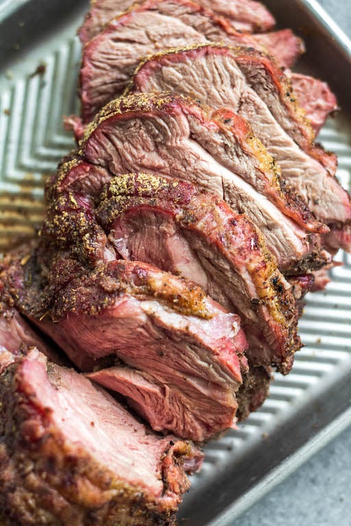 This easy smoked lamb roast is great for entertaining or a special family weekend dinner. It's healthy, quick to prepare and simple to cook on the smoker. It's also Whole30, low carb/keto, gluten-free and paleo, so no matter who's at your dinner table, everyone will enjoy! Seasoned to perfection with spices already in your pantry, this boneless lamb roast is juicy and full of flavor with very little hands on time! #whole30recipes #lambrecipes #smokerrecipes #ketosmoker #paleosmoker #smokedlamb