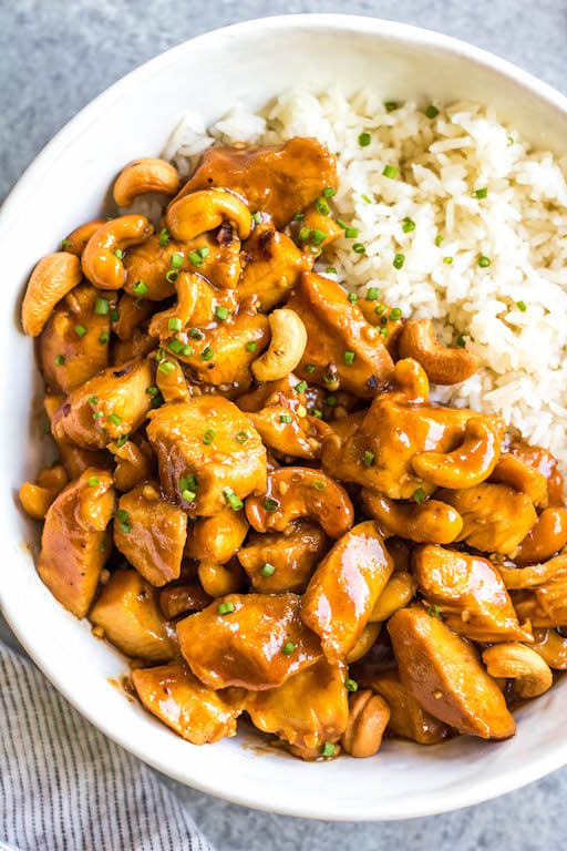 This slow cooker cashew chicken is an easy, healthy dinner or meal prep recipe. It's Whole30, paleo, gluten-free and soy-free, and only needs 10 minutes of prep work to dice chicken and make an easy sauce. The crockpot does the rest of the work, and you get a family friendly meal that's quick and simple to clean up. Paired with a vegetable side, this is the perfect go-to for a busy weeknight! #whole30slowcooker #cashewchicken #whole30chicken #glutenfreechicken #slowcookerrecipes #healthycashewchicken
