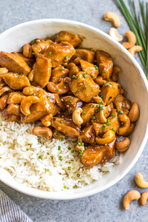 This slow cooker cashew chicken is an easy, healthy dinner or meal prep recipe. It's Whole30, paleo, gluten-free and soy-free, and only needs 10 minutes of prep work to dice chicken and make an easy sauce. The crockpot does the rest of the work, and you get a family friendly meal that's quick and simple to clean up. Paired with a vegetable side, this is the perfect go-to for a busy weeknight! #whole30slowcooker #cashewchicken #whole30chicken #glutenfreechicken #slowcookerrecipes #healthycashewchicken