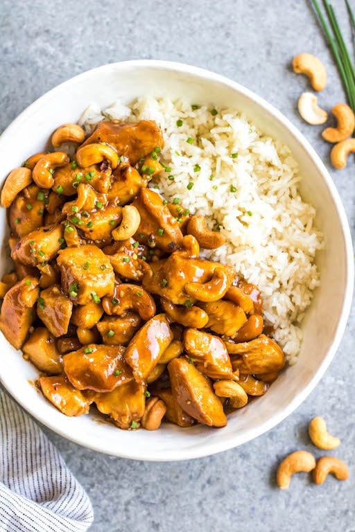 This slow cooker cashew chicken is an easy, healthy dinner or meal prep recipe. It's Whole30, paleo, gluten-free and soy-free, and only needs 10 minutes of prep work to dice chicken and make an easy sauce. The crockpot does the rest of the work, and you get a family friendly meal that's quick and simple to clean up. Paired with a vegetable side, this is the perfect go-to for a busy weeknight! #whole30slowcooker #cashewchicken #whole30chicken #glutenfreechicken #slowcookerrecipes #healthycashewchicken