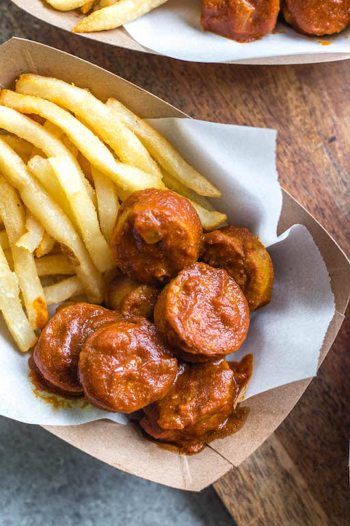 This homemade currywurst is a German street food staple. This version, while much like the traditional one, is sugar-free, Whole30 and paleo! You'll love it because it's such a burst of flavor, comforting, and cooks in under 30 minutes. It also only requires very few ingredients, making it perfect for lunch or an easy weeknight dinner recipe. #whole30germanrecipes #germanfood #whole30pork #paleopork #bratrecipes #lunchrecipes