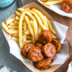 This homemade currywurst is a German street food staple. This version, while much like the traditional one, is sugar-free, Whole30 and paleo! You'll love it because it's such a burst of flavor, comforting, and cooks in under 30 minutes. It also only requires very few ingredients, making it perfect for lunch or an easy weeknight dinner recipe. #whole30germanrecipes #germanfood #whole30pork #paleopork #bratrecipes #lunchrecipes