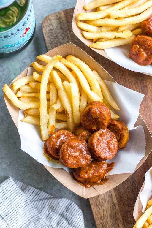 This homemade currywurst is a German street food staple. This version, while much like the traditional one, is sugar-free, Whole30 and paleo! You'll love it because it's such a burst of flavor, comforting, and cooks in under 30 minutes. It also only requires very few ingredients, making it perfect for lunch or an easy weeknight dinner recipe. #whole30germanrecipes #germanfood #whole30pork #paleopork #bratrecipes #lunchrecipes