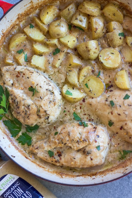 This Whole30 dijon chicken and potato skillet is an easy and healthy one pan meal. It's perfect for a weeknight dinner or meal prep for lunches, and it's also paleo and gluten-free! The chicken breasts and potatoes are sautéed in garlic, and then baked in a creamy dijon sauce, and the result is a simple, flavorful Whole30 dinner recipe everyone will love! #whole30recipes #onepotmeal #whole30chicken #glutenfreechicken #dijonrecipes #oneskillet