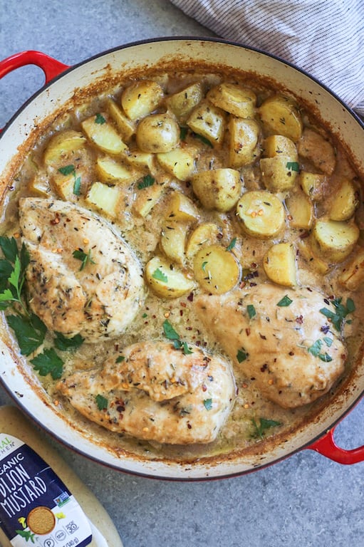 This Whole30 dijon chicken and potato skillet is an easy and healthy one pan meal. It's perfect for a weeknight dinner or meal prep for lunches, and it's also paleo and gluten-free! The chicken breasts and potatoes are sautéed in garlic, and then baked in a creamy dijon sauce, and the result is a simple, flavorful Whole30 dinner recipe everyone will love! #whole30recipes #onepotmeal #whole30chicken #glutenfreechicken #dijonrecipes #oneskillet