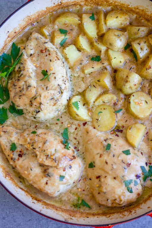 This Whole30 dijon chicken and potato skillet is an easy and healthy one pan meal. It's perfect for a weeknight dinner or meal prep for lunches, and it's also paleo and gluten-free! The chicken breasts and potatoes are sautéed in garlic, and then baked in a creamy dijon sauce, and the result is a simple, flavorful Whole30 dinner recipe everyone will love! #whole30recipes #onepotmeal #whole30chicken #glutenfreechicken #dijonrecipes #oneskillet