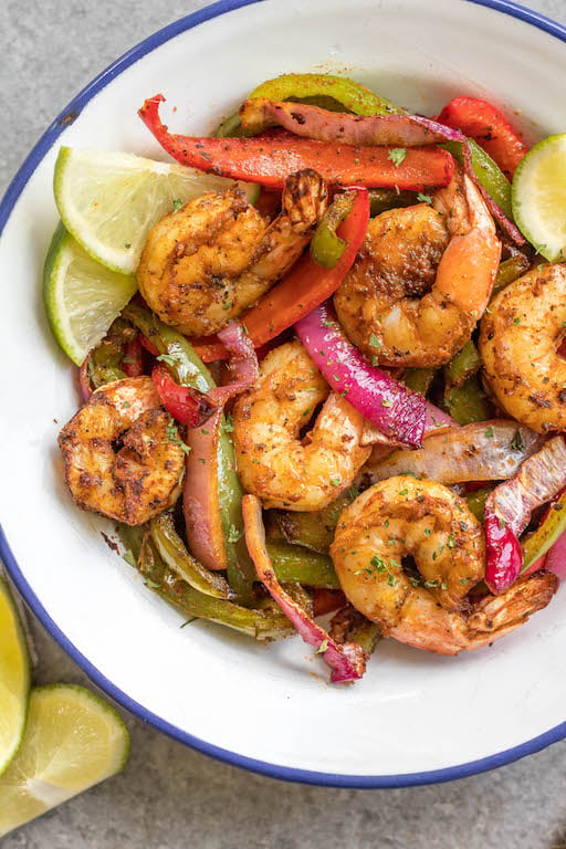 These air fryer shrimp fajitas are great for a quick and easy weeknight dinner, taco night, meal prep, or simple healthy lunch. They are very simple to toss together, with minimal hands on time, and are Whole30, paleo, keto/low carb, and gluten-free! The homemade fajita seasoning adds the perfect flavor to the bell peppers, onion and shrimp! #whole30airfryer #shrimpfajitas #airfryerrecipes #ketoairfryer #whole30shrimp #glutenfree