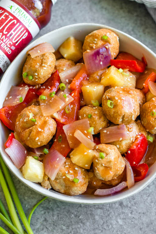 These sweet and sour chicken meatballs are made in the slow cooker, and are paleo, gluten-free and easily made Whole30! It takes less than 20 minutes to prepare, and then the crock pot does the cooking for you. These Whole30 meatballs are perfect for a weeknight dinner, or meal prep for easy, healthy lunches. It's a family friendly recipe that has the flavors you love from your favorite Chinese takeout! #whole30recipes #whole30slowcooker #crockpot #sweetandsour #chickenrecipes