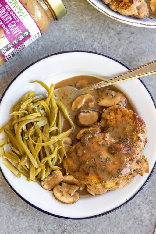 This easy chicken thighs and mushroom skillet is a 30 minute one pan meal that's ideal for busy weeknights! It's full of flavor from a creamy, rich gravy, while still being Whole30, paleo, gluten-free, and dairy-free! There's only a few simple ingredients which makes this dish come together quickly, and it's great for a healthy meal prep recipe because it reheats incredibly well. This is a family-friendly recipe everyone will love! #onepan #whole30chicken #chickenthighs #mushroomrecipes #paleorecipes #glutenfreechicken #weeknightchicken