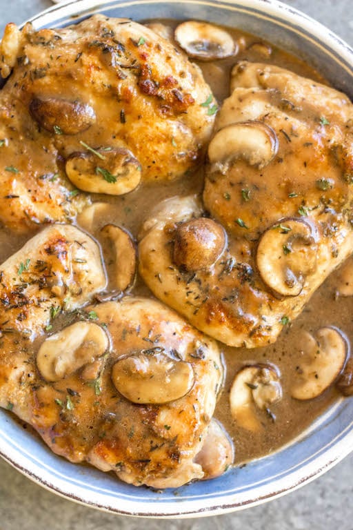 This easy chicken thighs and mushroom skillet is a 30 minute one pan meal that's ideal for busy weeknights! It's full of flavor from a creamy, rich gravy, while still being Whole30, paleo, gluten-free, and dairy-free! There's only a few simple ingredients which makes this dish come together quickly, and it's great for a healthy meal prep recipe because it reheats incredibly well. This is a family-friendly recipe everyone will love! #onepan #whole30chicken #chickenthighs #mushroomrecipes #paleorecipes #glutenfreechicken #weeknightchicken