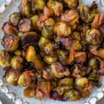 These maple bacon Brussels sprouts are an easy, healthy side dish that works for both the holidays or just a delicious way to prep a vegetable side for a weeknight dinner! There are only 4 simple ingredients and one dish needed, which makes them a quick paleo, gluten-free and dairy-free vegetable recipe option that the whole family will love. The crispy bacon and maple flavors will have everyone eating their Brussels sprouts! #vegetablesides #holidayrecipes #paleovegetables #brusselssprouts #baconrecipes