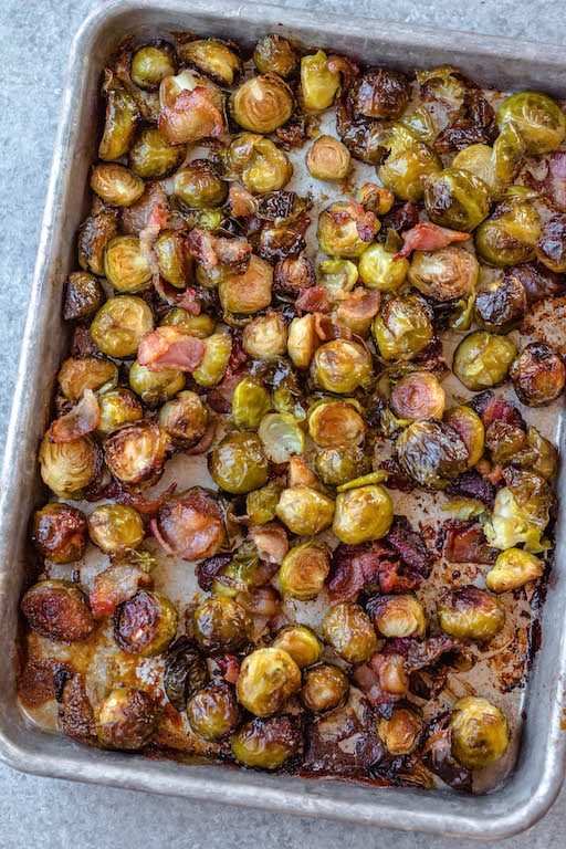 These maple bacon Brussels sprouts are an easy, healthy side dish that works for both the holidays or just a delicious way to prep a vegetable side for a weeknight dinner! There are only 4 simple ingredients and one dish needed, which makes them a quick paleo, gluten-free and dairy-free vegetable recipe option that the whole family will love. The crispy bacon and maple flavors will have everyone eating their Brussels sprouts! #vegetablesides #holidayrecipes #paleovegetables #brusselssprouts #baconrecipes