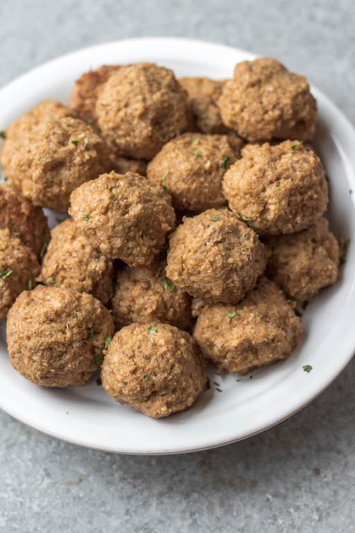 These gluten free vegetarian meatballs are so easy, perfect for meal prep, and only 4 ingredients! In under a half hour, you can have a healthy weeknight dinner or option for affordable, meatless workweek lunches. Made with cauliflower, brown rice and walnuts, they're also soy-free and dairy-free meatballs. These pair perfectly with any sauce, pasta or salad. They also freeze wonderfully, so go ahead and make a double batch! #meatlessrecipes #vegetarianmeatballs #glutenfreevegetarian #soyfreevegetarian #meatlessmeatballs