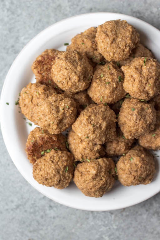 These gluten free vegetarian meatballs are so easy, perfect for meal prep, and only 4 ingredients! In under a half hour, you can have a healthy weeknight dinner or option for affordable, meatless workweek lunches. Made with cauliflower, brown rice and walnuts, they're also soy-free and dairy-free meatballs. These pair perfectly with any sauce, pasta or salad. They also freeze wonderfully, so go ahead and make a double batch! #meatlessrecipes #vegetarianmeatballs #glutenfreevegetarian #soyfreevegetarian #meatlessmeatballs