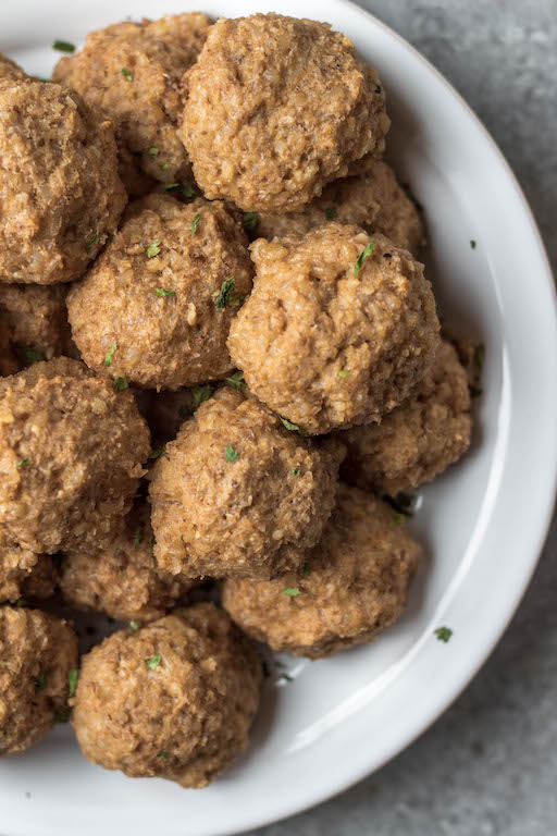 These gluten free vegetarian meatballs are so easy, perfect for meal prep, and only 4 ingredients! In under a half hour, you can have a healthy weeknight dinner or option for affordable, meatless workweek lunches. Made with cauliflower, brown rice and walnuts, they're also soy-free and dairy-free meatballs. These pair perfectly with any sauce, pasta or salad. They also freeze wonderfully, so go ahead and make a double batch! #meatlessrecipes #vegetarianmeatballs #glutenfreevegetarian #soyfreevegetarian #meatlessmeatballs