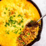 This Whole30 Shepherd's Pie recipe is baked in an oven proof skillet which makes the cooking process simple and easy. It's also a budget-friendly ground beef recipe that's paleo, gluten-free, dairy-free and can be made low carb. With vegetables like carrots, onions, celery and peas mixed in with a flavorful gravy, the filling is a perfect companion for the creamy mashed potatoes. It's a hearty, cozy recipe that's family friendly and also great for meal prep! #groundbeefrecipes #whole30beef #whole30recipes #paleogroundbeef