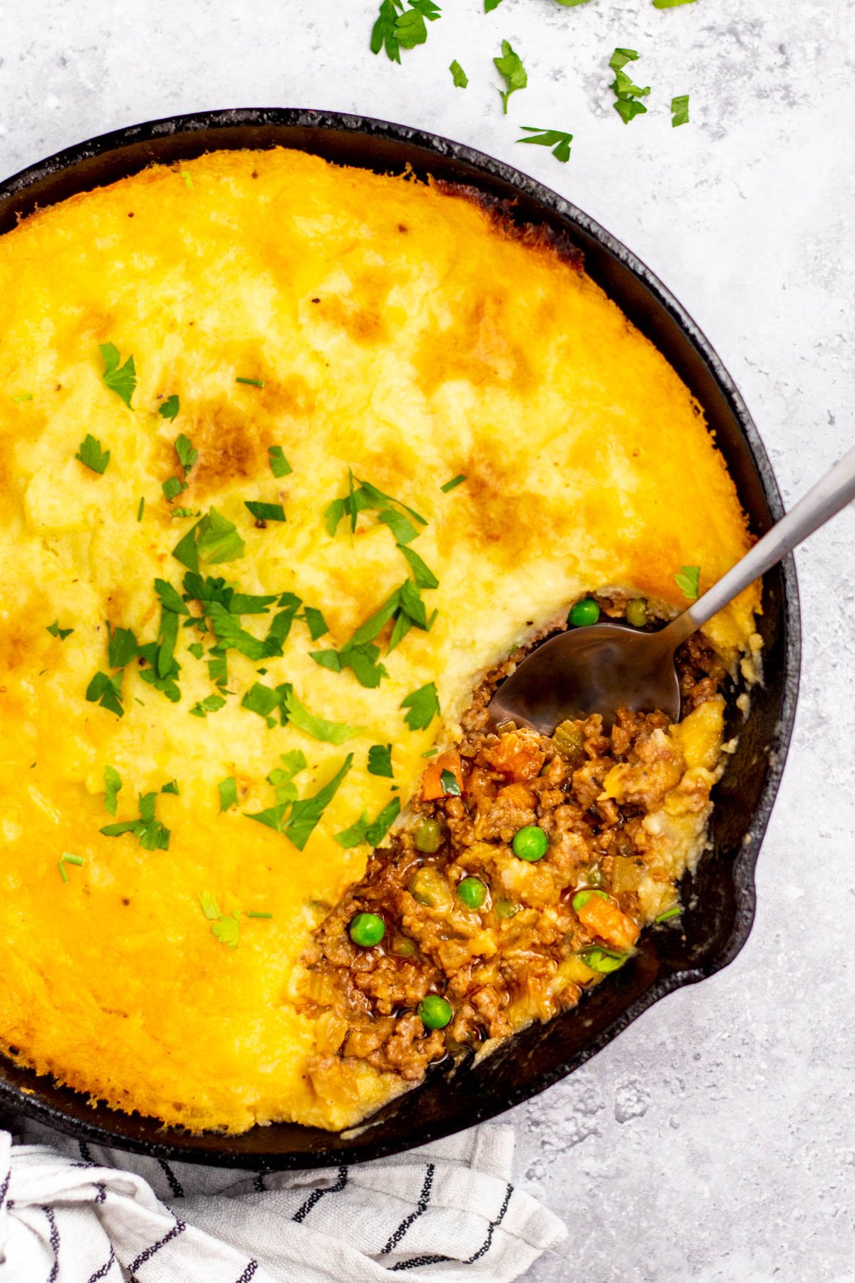 This Whole30 Shepherd's Pie recipe is baked in an oven proof skillet which makes the cooking process simple and easy. It's also a budget-friendly ground beef recipe that's paleo, gluten-free, dairy-free and can be made low carb. With vegetables like carrots, onions, celery and peas mixed in with a flavorful gravy, the filling is a perfect companion for the creamy mashed potatoes. It's a hearty, cozy recipe that's family friendly and also great for meal prep! #groundbeefrecipes #whole30beef #whole30recipes #paleogroundbeef