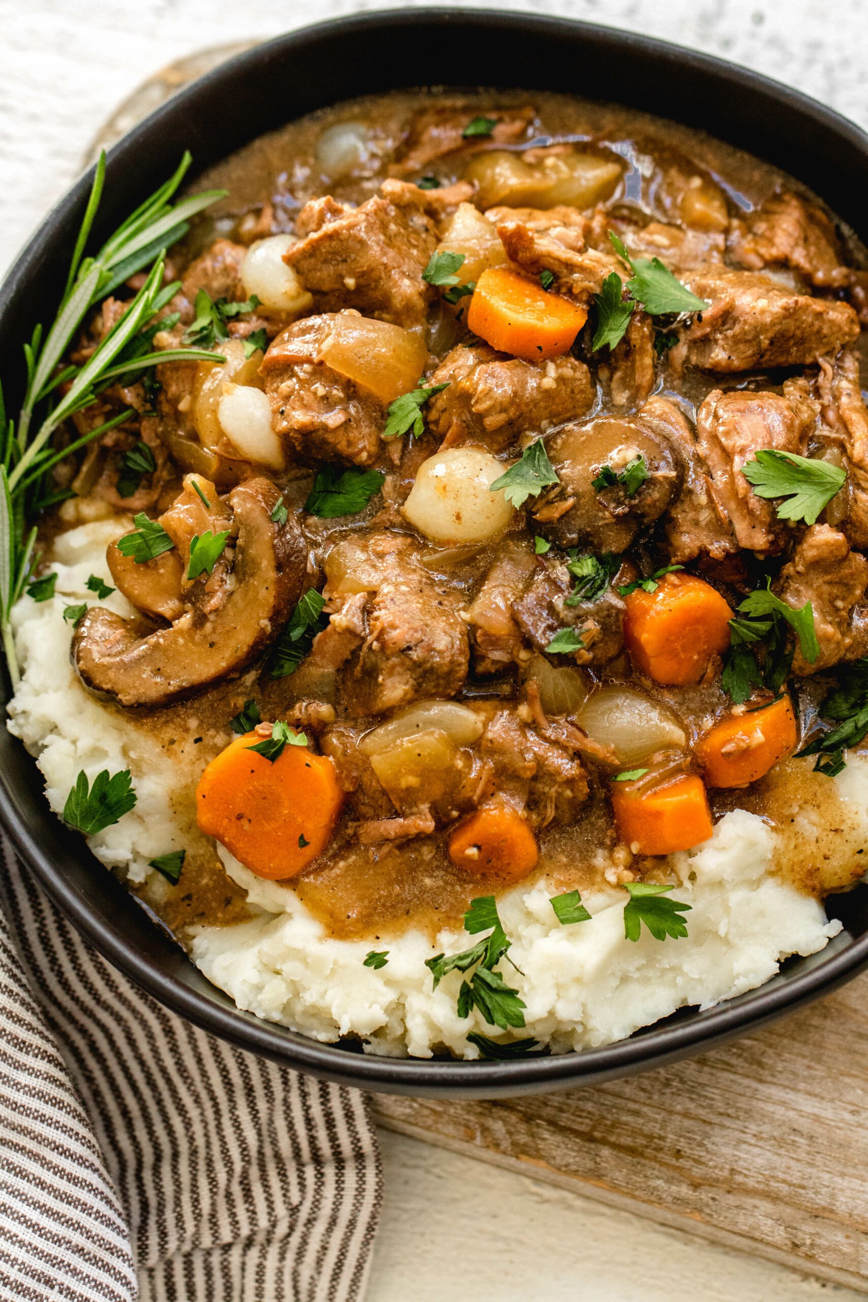 This Whole30 slow cooker beef bourguignon is an easy set it and forget recipe. It's paleo, gluten-free and dairy-free, full of vegetables and rich in flavor. Beef bourguignon in the crockpot is made with stew meat, and is ideal for a simple weeknight dinner or meal prep recipe to use for lunches. It's also freezer friendly, and this Whole30 beef recipe is sure to be a family favorite! #whole30slowcooker #whole30beef