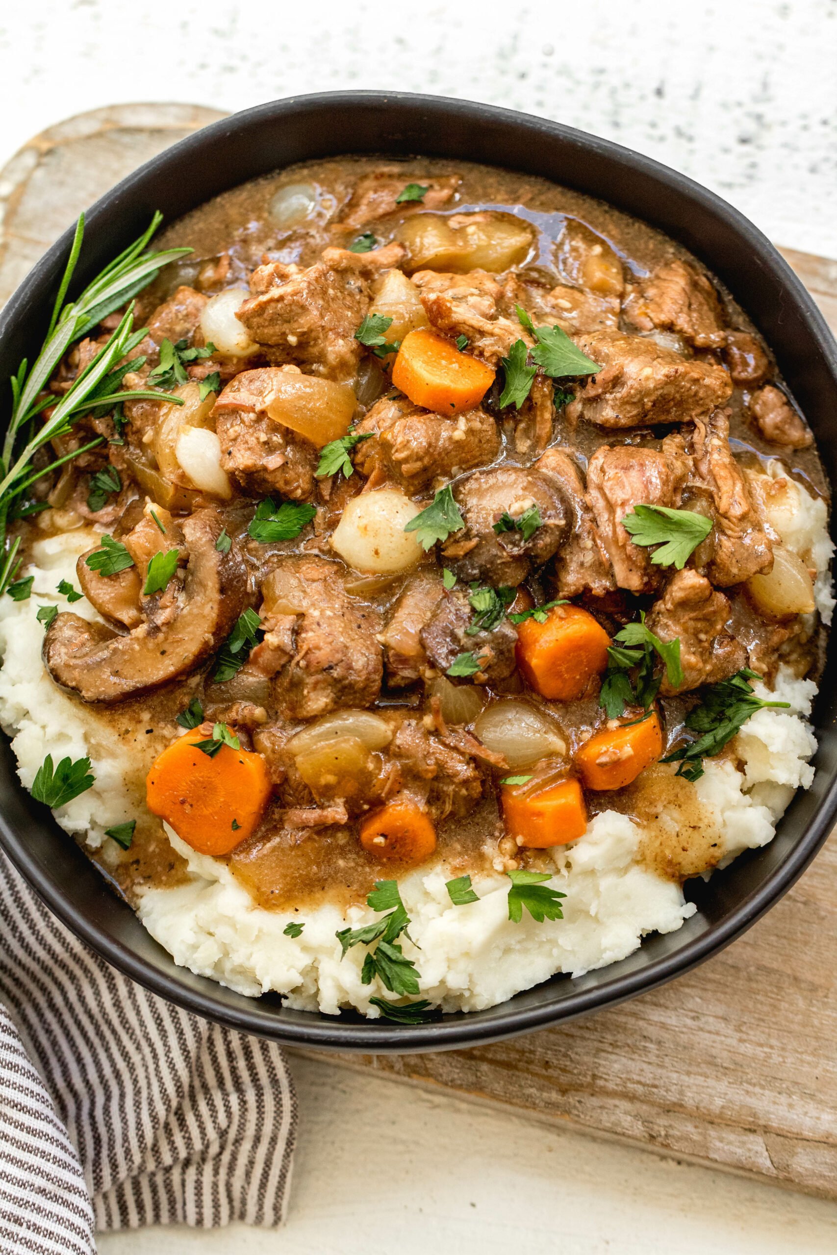 This Whole30 slow cooker beef bourguignon is an easy set it and forget recipe. It's paleo, gluten-free and dairy-free, full of vegetables and rich in flavor. Beef bourguignon in the crockpot is made with stew meat, and is ideal for a simple weeknight dinner or meal prep recipe to use for lunches. It's also freezer friendly, and this Whole30 beef recipe is sure to be a family favorite! #whole30slowcooker #whole30beef