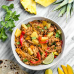 This easy Whole30 slow cooker Hawaiian chicken fajitas recipe is perfect for an easy family-friendly weeknight meal. It's a simple set it and forget crockpot meal that's also paleo, gluten-free and dairy-free. The tender, fall apart chicken thighs and vegetables can be served in wraps, as a salad over greens, or as part of a taco bar! #whole30chicken #whole30slowcooker #whole30fajitas #chickenfajitas