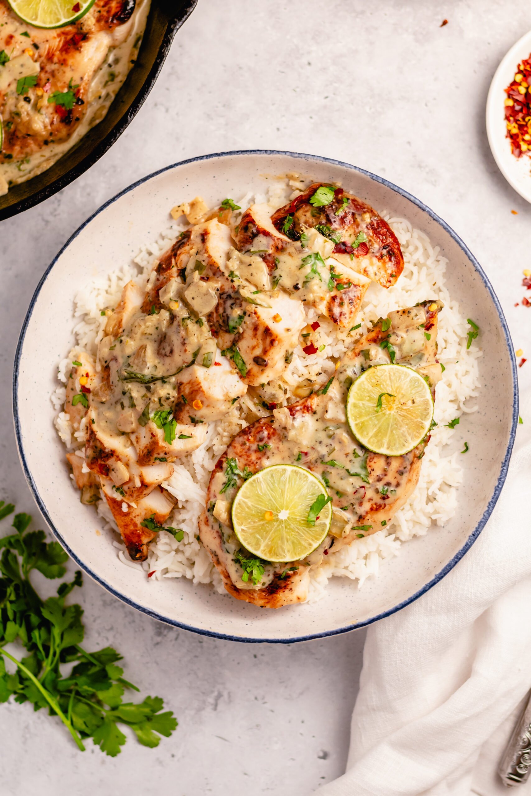 This Whole30 coconut lime chicken skillet is a gluten free, dairy free, and paleo chicken recipe that is made all in one pan! The creamy coconut sauce and chicken breasts are perfectly seasoned with lime, onion, cilantro and garlic. It all comes together in about 30 minutes, and is great for an easy Whole30 dinner that's family friendly, or a healthy meal prep recipe for lunches during the week. #coconutchicken #whole30chicken #whole30skillet #onepanmeal