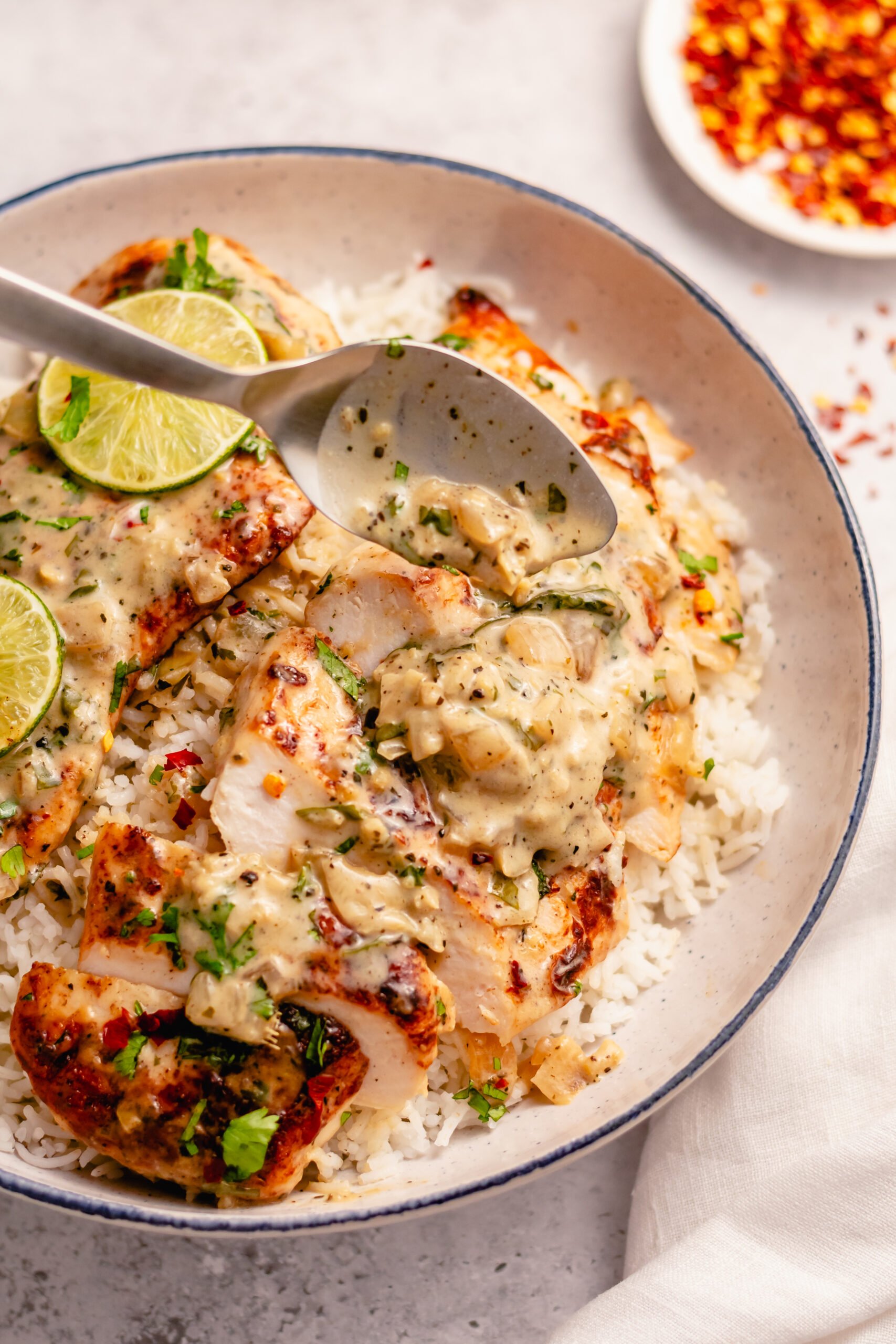 This Whole30 coconut lime chicken skillet is a gluten free, dairy free, and paleo chicken recipe that is made all in one pan! The creamy coconut sauce and chicken breasts are perfectly seasoned with lime, onion, cilantro and garlic. It all comes together in about 30 minutes, and is great for an easy Whole30 dinner that's family friendly, or a healthy meal prep recipe for lunches during the week. #coconutchicken #whole30chicken #whole30skillet #onepanmeal