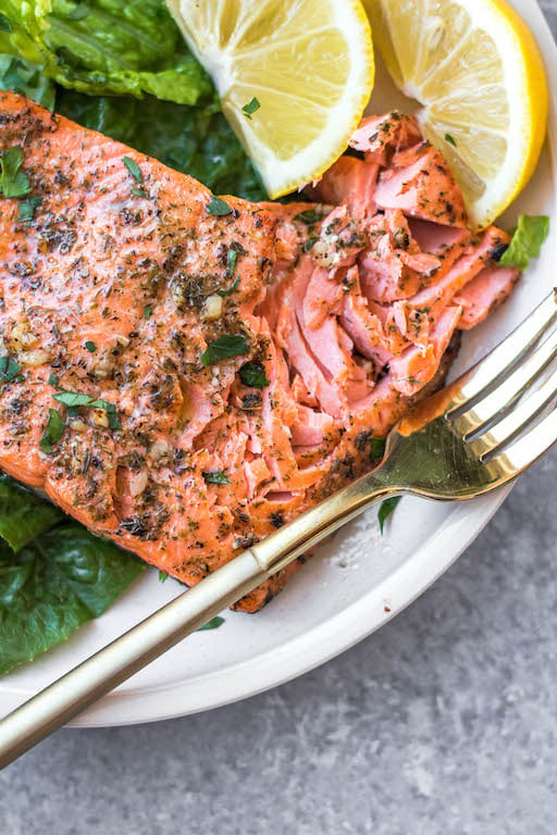 This oven baked Whole30 Greek salmon recipe is an easy way to meal prep or make a quick weeknight meal. It bakes in 15 minutes or cooks in the air fryer in just 10 minutes. This Whole30 salmon is also gluten free, low carb and paleo, so everyone can enjoy it! Lemon juice and a blend of spices like oregano, dill and basil in the marinade will ensure your salmon is bursting with flavor. #whole30salmon #greeksalmon #airfryersalmon #ovenbakedsalmon