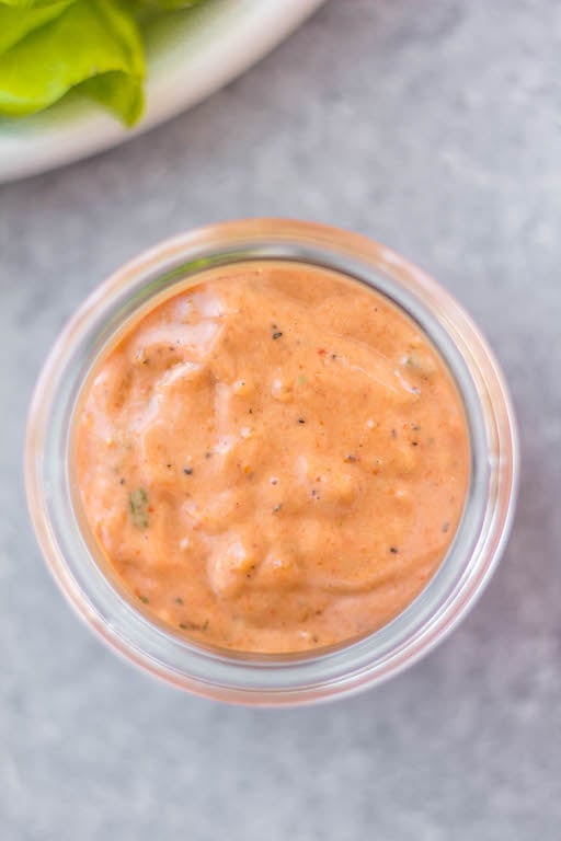 This Whole30 homemade thousand island dressing is so easy to make. It's a smooth, tangy homemade dressing that takes less than 5 minutes to mix together! This DIY dressing is also gluten-free, dairy-free, keto/low carb, and paleo thousand island. It's the perfect addition to salads, burgers, wraps and to dip your fries or veggies in. #whole30dressing #whole30thousandisland #homemadedressing #healthythousandisland