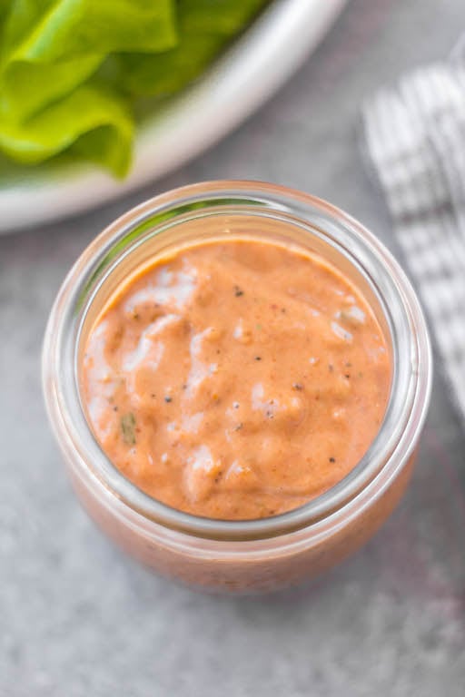 This Whole30 homemade thousand island dressing is so easy to make. It's a smooth, tangy homemade dressing that takes less than 5 minutes to mix together! This DIY dressing is also gluten-free, dairy-free, keto/low carb, and paleo thousand island. It's the perfect addition to salads, burgers, wraps and to dip your fries or veggies in. #whole30dressing #whole30thousandisland #homemadedressing #healthythousandisland