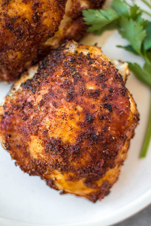 These Whole30 air fryer bone in chicken thighs are so simple and flavorful. The skin gets crispy while the inside stays juicy and tender. They're the perfect option for a quick weeknight dinner and are done in under 30 minutes. Not only are these bone in chicken thighs Whole30, but they're also paleo, gluten free and low carb. #airfryerchicken #whole30airfryer #paleorecipes #glutenfreeairfryer #chickenthighs