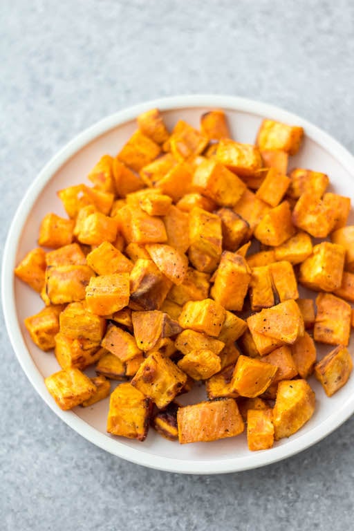 These air fryer roasted sweet potatoes are a quick and easy vegetable side for breakfast, dinner or meal prep. They're Whole30, paleo and gluten-free, and only take 15 minutes! With only 3 ingredients, these air fryer diced sweet potatoes cook in half the time as they would in the oven, and are perfectly crispy every time! #whole30vegetables #airfryer #sweetpotatorecipes #airfryerpotatoes