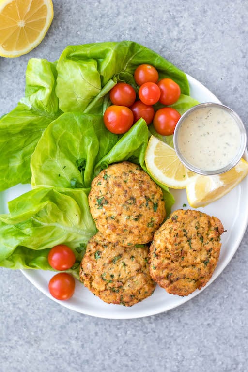 This easy Whole30 air fryer salmon patties are under 10 ingredients, take less than 20 minutes to prep and cook, and are an awesome meal prep recipe. They're also paleo, low carb and keto, and gluten-free! These air fryer patties are made with canned salmon so it's a budget friendly Whole30 recipe made from simple pantry ingredients. #whole30airfryer #whole30salmon #airfryersalmon #salmonpatties #whole30seafood