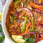 The Chicken Fajita Casserole is a low carb, gluten free and paleo friendly meal that is easy to make and sure to be a hit! It's packed with all of the chicken fajita flavors you love and full of fresh and healthy ingredients like shredded chicken, bell peppers, cauliflower rice, and onions - all wrapped up in a casserole dish! It's perfect for both a weeknight dinner and for meal prep for lunches. This delicious Whole30 casserole is a must try. #chickenfajita #chickencasserole #whole30casserole #whole30chickenrecipes