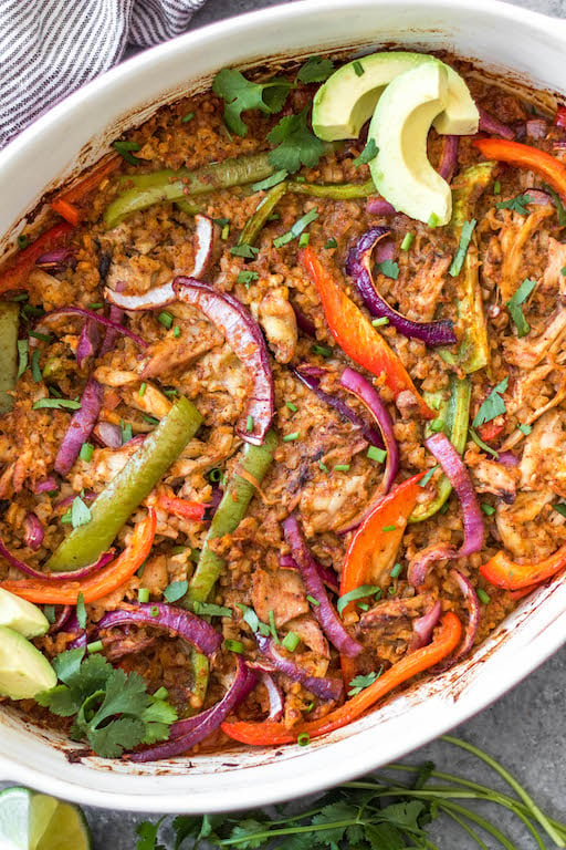 The Chicken Fajita Casserole is a low carb, gluten free and paleo friendly meal that is easy to make and sure to be a hit! It's packed with all of the chicken fajita flavors you love and full of fresh and healthy ingredients like shredded chicken, bell peppers, cauliflower rice, and onions - all wrapped up in a casserole dish! It's perfect for both a weeknight dinner and for meal prep for lunches. This delicious Whole30 casserole is a must try. #chickenfajita #chickencasserole #whole30casserole #whole30chickenrecipes