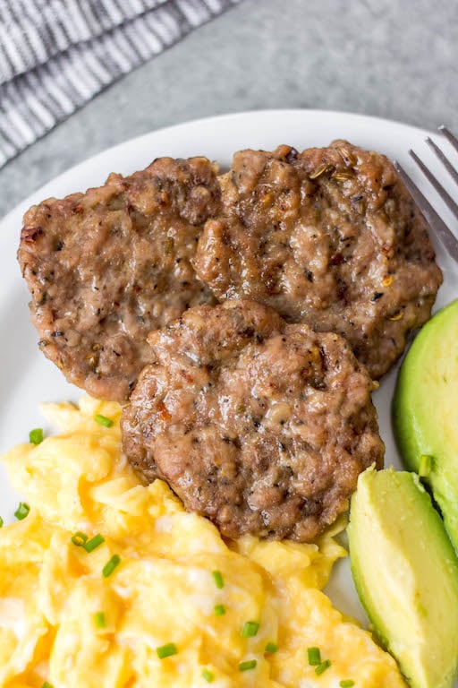 This easy homemade maple breakfast sausage recipe is so simple to make, perfect for meal prepping, and it's freezer friendly! These DIY maple sausages are gluten free, low carb, paleo and only use a few ingredients including ground pork and spices, and only a few minutes time. You can oven bake them or cook them up in a skillet, and they come out delicious every time! #groundporkrecipes #breakfastsausage #freezerrecipes