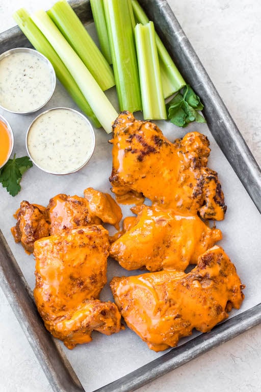 These buffalo chicken thighs are naturally gluten and dairy free. This versatile recipe can be made in both by being baked in the oven and cooked in the air fryer. It is made with a total of 5 staple ingredients you likely already have on hand alongside boneless chicken thighs and your go-to buffalo sauce. They take less than 30 minutes, and make an easy, healthy, dinner everyone will love.