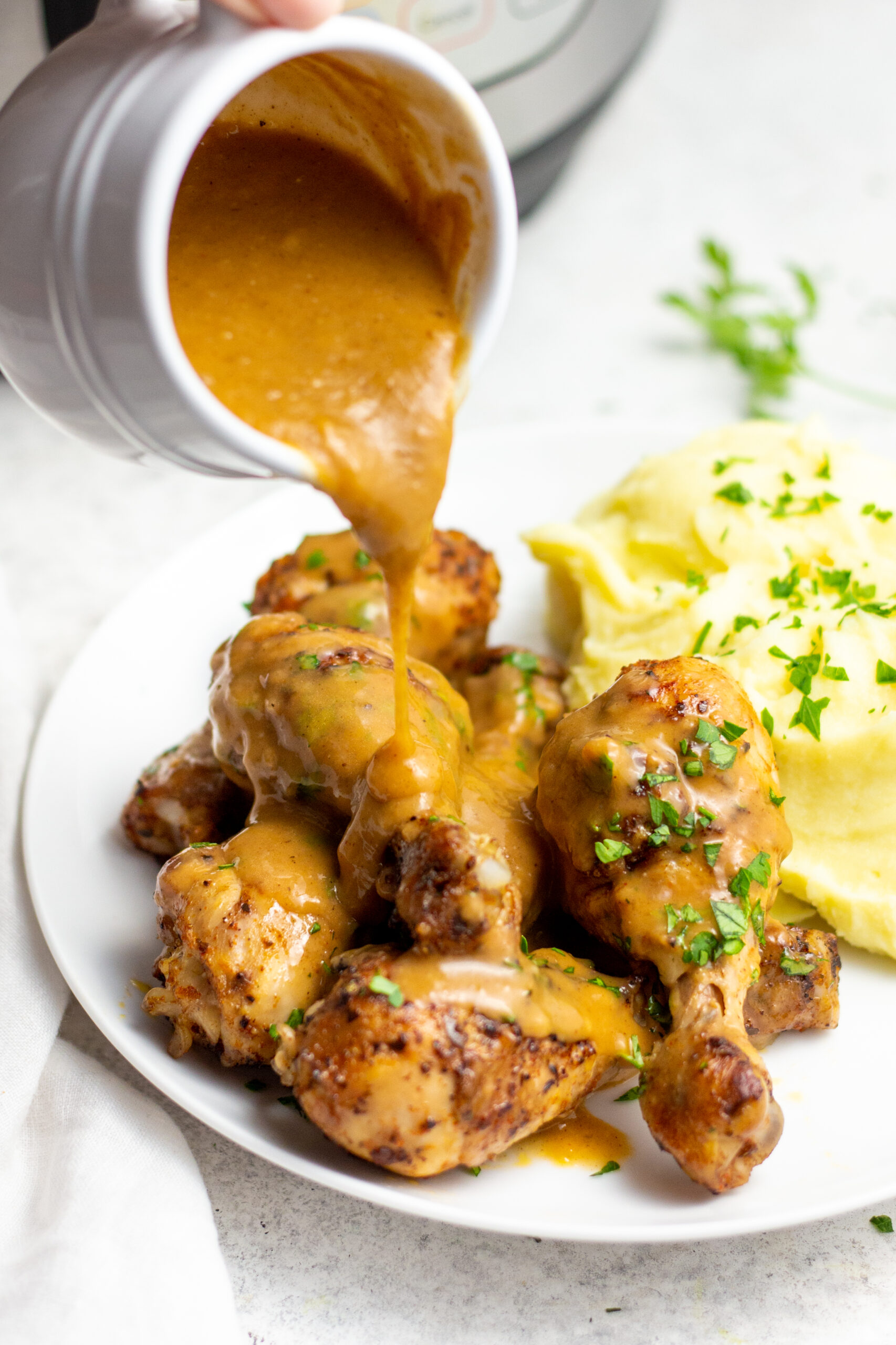 These instant pot chicken drumsticks are a fast way to get perfect chicken drumsticks without a lot of mess. They are both gluten and dairy free and are absolutely delicious. The homemade gravy makes this recipe perfect for a classic chicken and mashed potato meal the whole family will love, plus it's Whole30, paleo and low carb! This 30 minute, no mess instant pot chicken is sure to be a hit! #healthyrecipes #glutenfreerecipes #dairyfreerecipes #whole30recipes #glutenfreedairyfreerecipes #healthychickenrecipes #chickendrumsticks