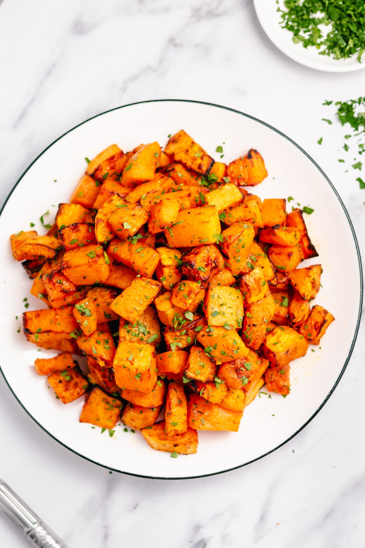 Butternut squash is a simple side that can go with almost anything. This air fryer recipe is paleo, Whole30, and gluten free. Using only a few staple ingredients it is ready in twenty minutes from start to finish. Add a new fresh and healthy side to your rotation with this air fryer butternut squash recipe! #healthyairfryerrecipes #butternutsquashrecipes #butternutsquash #glutenfreerecipes #dairyfreerecipes #glutenfreedairyfreerecipes