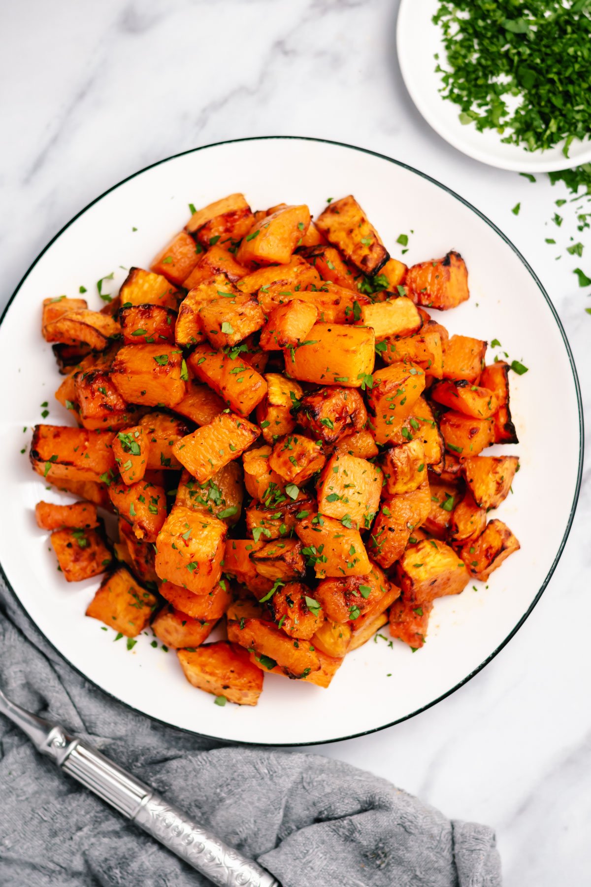 Butternut squash is a simple side that can go with almost anything. This air fryer recipe is paleo, Whole30, and gluten free. Using only a few staple ingredients it is ready in twenty minutes from start to finish. Add a new fresh and healthy side to your rotation with this air fryer butternut squash recipe! #healthyairfryerrecipes #butternutsquashrecipes #butternutsquash #glutenfreerecipes #dairyfreerecipes #glutenfreedairyfreerecipes