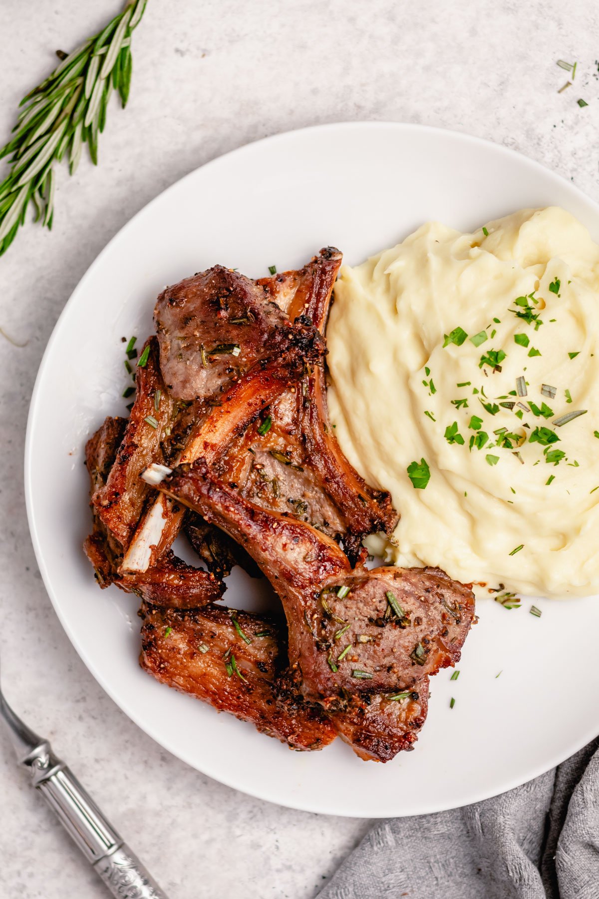 These air fryer lamb chops are among the easiest and fastest ways to get a delicious lamb entree on the table. They are both dairy free and gluten free, along with completely paleo and Whole30 lamb chops. This recipe goes with almost anything and takes 20 minutes from start to finish. Impress your friends and become a lamb chop expert overnight with this recipe! #glutenfreerecipes #dairyfreerecipes #glutenfreedairyfreerecipes #20minutemeals #whole30recipes #healthylambrecipes #airfryerrecipes