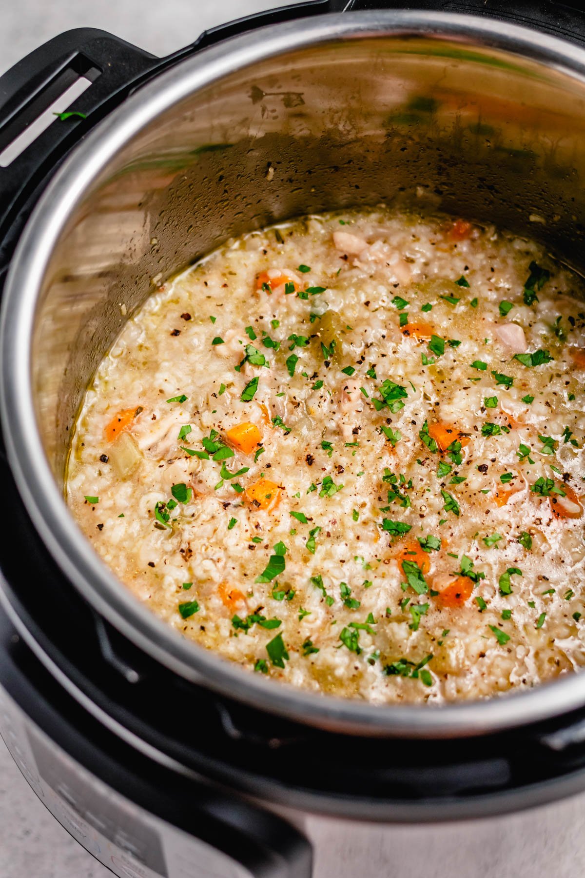 Instant pot chicken and rice soup is the perfect way to get a fulfilling, hearty soup on the table fast. It has minimal prep and is both gluten free and dairy free, and because it's done in the instant pot there's only one dish to clean. This chicken soup is perfect for a family meal on its own or a starter or side for a gathering. Plus it's ready in under 30 minutes! #glutenfreerecipes #dairyfreerecipes #healthychickenrecipes #chickensouprecipes #glutenfreedairyfreerecipes #instantpotrecipes