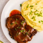 This instant pot steak is so flavorful and so easy. It cooks in the pressure cooker in under 20 minutes, and is perfect for a quick weeknight recipe. A delicious gravy can be made right in the instant pot with the juices to serve over the steak or with mashed potatoes, and everything is gluten free, Whole30, low carb so everyone can enjoy this healthy dinner. #instantpotsteak #pressurecookersteak #instantpotbeef #whole30instantpot