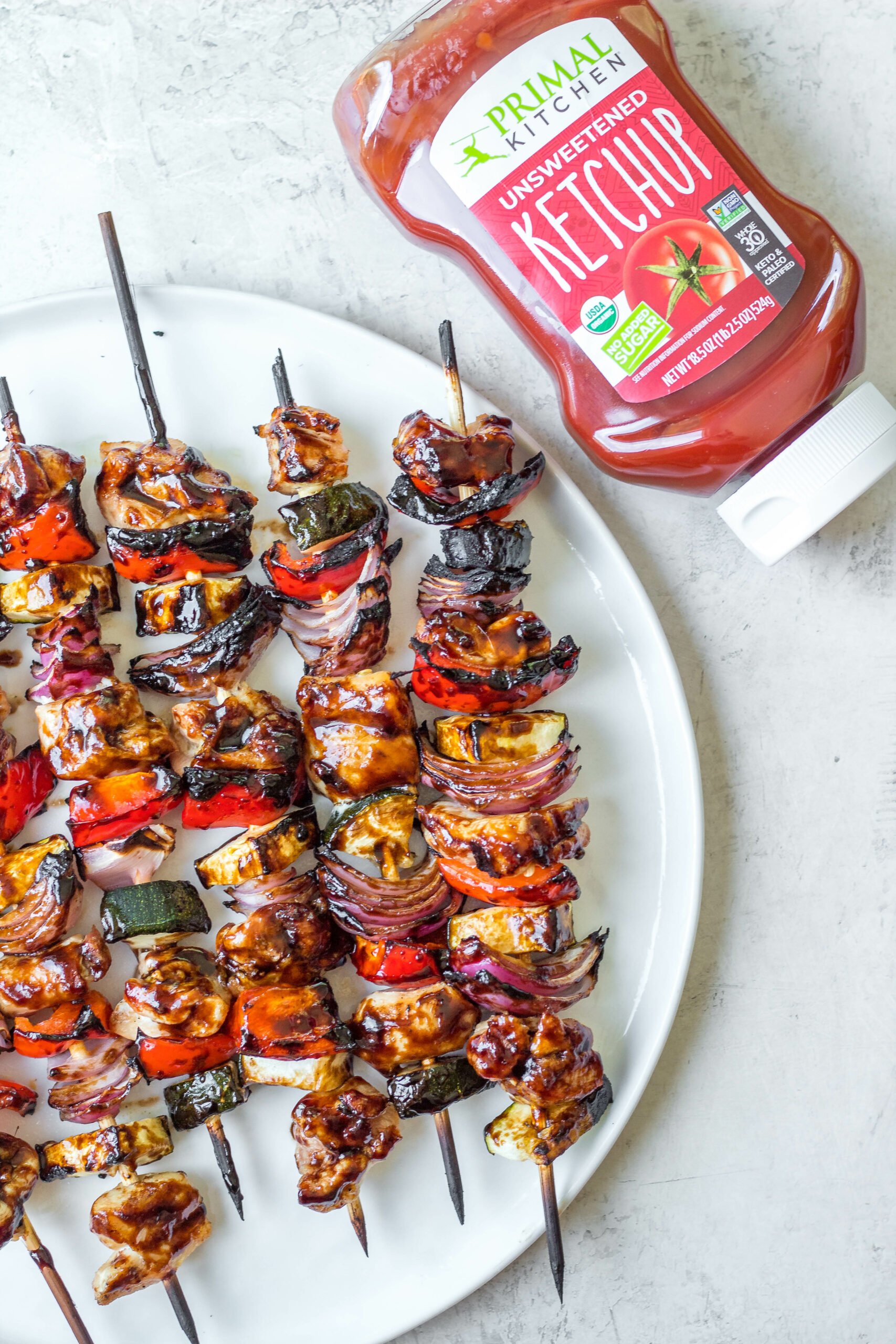 This honey balsamic grilled chicken kabob recipe is perfect for any summer dinner or family gathering. Made with lots of vegetables including zucchini, red onion and red pepper, these grilled chicken kabobs are quick to prep and grill, and glazed with an easy honey balsamic sauce! They're gluten free, low carb and paleo, so everyone can and will enjoy! #grilledchicken #chickenkabobs #balsamic #grilling