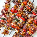 This honey balsamic grilled chicken kabob recipe is perfect for any summer dinner or family gathering. Made with lots of vegetables including zucchini, red onion and red pepper, these grilled chicken kabobs are quick to prep and grill, and glazed with an easy honey balsamic sauce! They're gluten free, low carb and paleo, so everyone can and will enjoy! #grilledchicken #chickenkabobs #balsamic #grilling