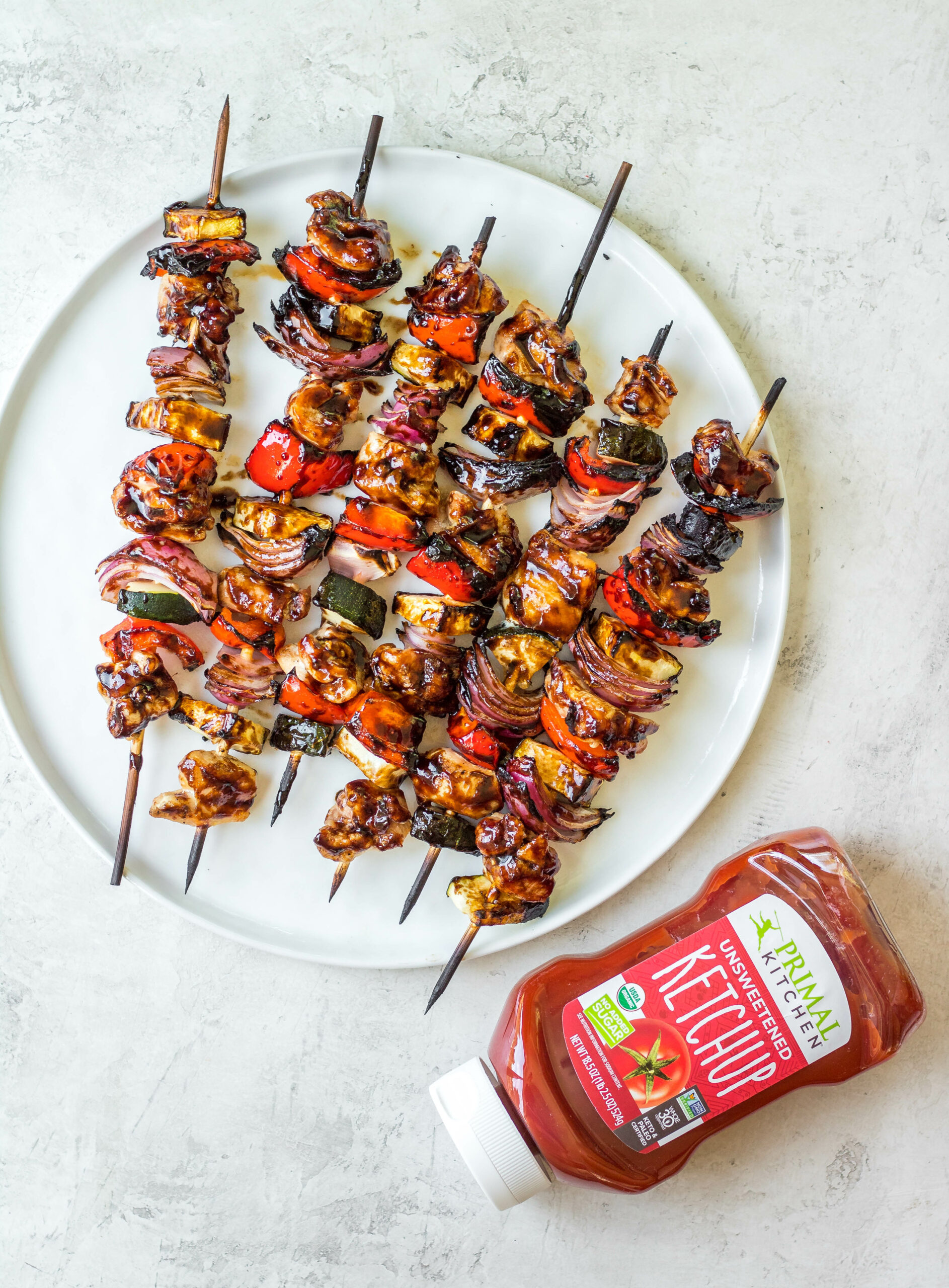 This honey balsamic grilled chicken kabob recipe is perfect for any summer dinner or family gathering. Made with lots of vegetables including zucchini, red onion and red pepper, these grilled chicken kabobs are quick to prep and grill, and glazed with an easy honey balsamic sauce! They're gluten free, low carb and paleo, so everyone can and will enjoy! #grilledchicken #chickenkabobs #balsamic #grilling