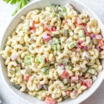 This easy, creamy macaroni salad is a flavorful pasta salad side dish that is the perfect combination of sweet and tart. The mayo based dressing is simple and not too overpowering, and it's sure to be a hit at every potluck or BBQ this summer! Made with sweet pickles, red onion, celery and red pepper, it can be made gluten free, dairy free, vegan and in under 30 minutes! #creamypastasalad #veganmacaronisalad #macaronisalad #sidedish