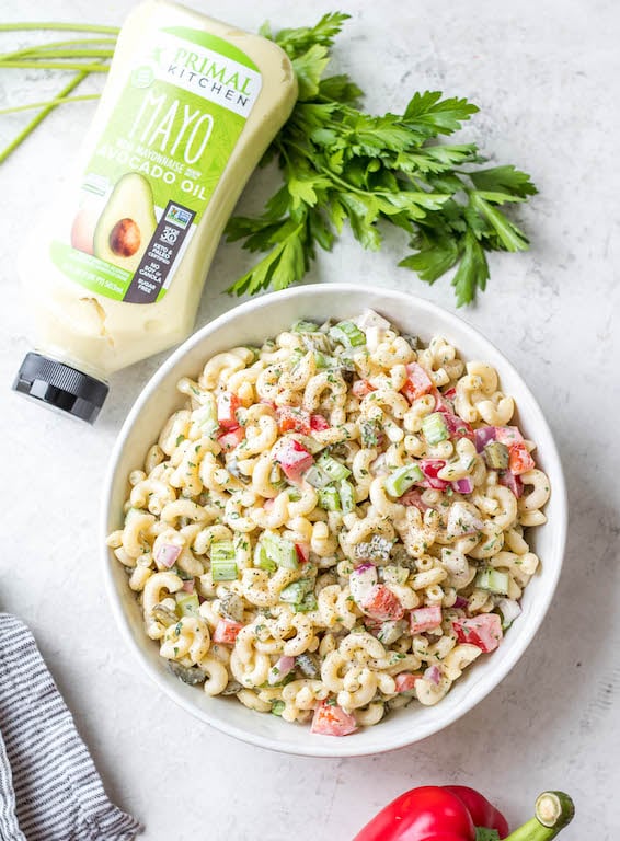 This easy, creamy macaroni salad is a flavorful pasta salad side dish that is the perfect combination of sweet and tart. The mayo based dressing is simple and not too overpowering, and it's sure to be a hit at every potluck or BBQ this summer! Made with sweet pickles, red onion, celery and red pepper, it can be made gluten free, dairy free, vegan and in under 30 minutes! #creamypastasalad #veganmacaronisalad #macaronisalad #sidedish