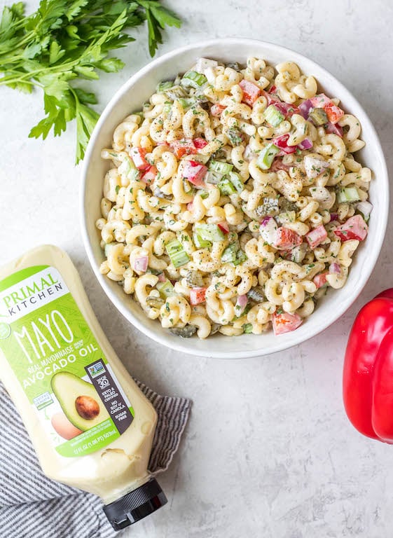 This easy, creamy macaroni salad is a flavorful pasta salad side dish that is the perfect combination of sweet and tart. The mayo based dressing is simple and not too overpowering, and it's sure to be a hit at every potluck or BBQ this summer! Made with sweet pickles, red onion, celery and red pepper, it can be made gluten free, dairy free, vegan and in under 30 minutes! #creamypastasalad #veganmacaronisalad #macaronisalad #sidedish